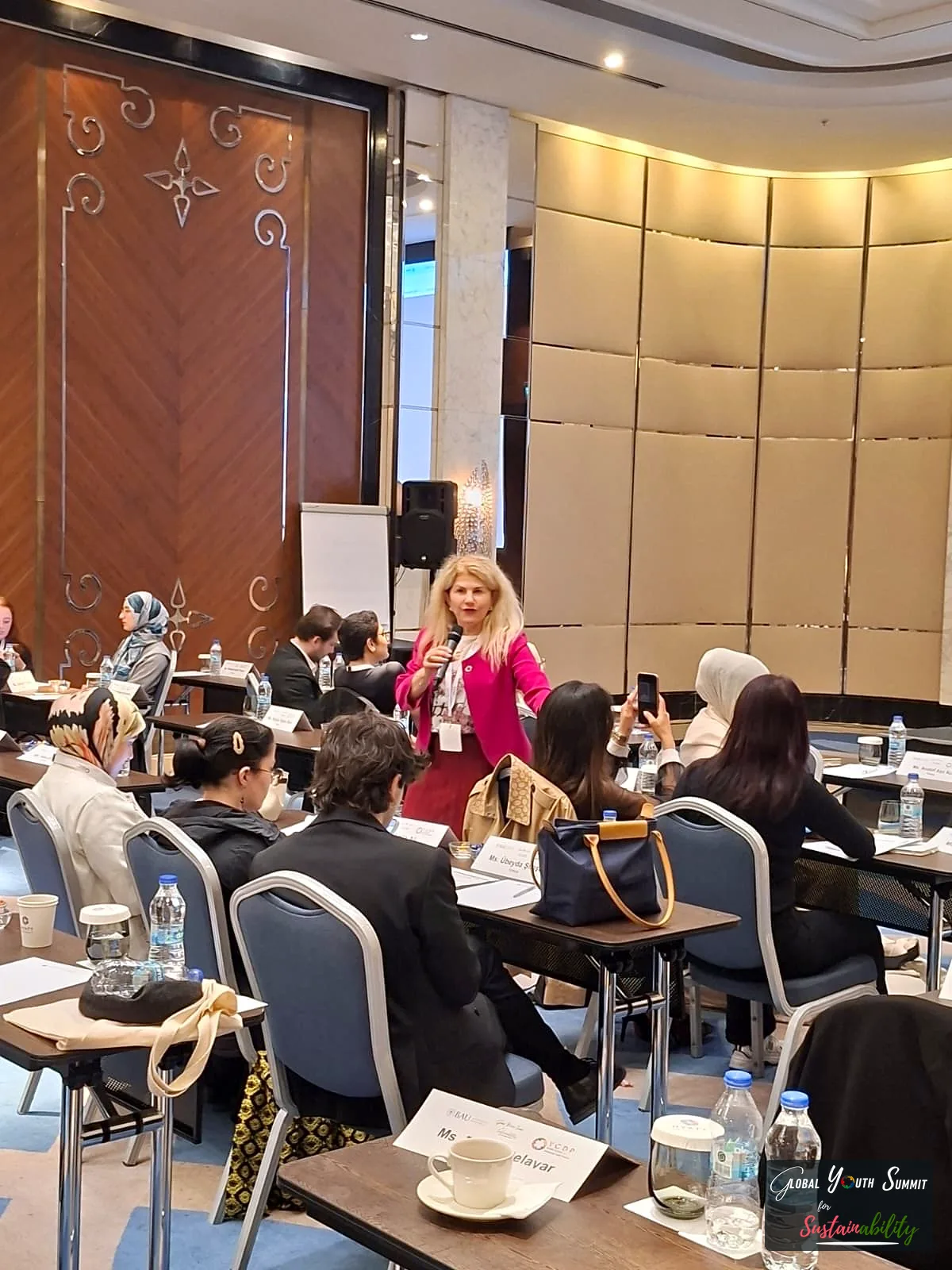 Prof. Hulya Kurt leading a session with delegates seated at tables